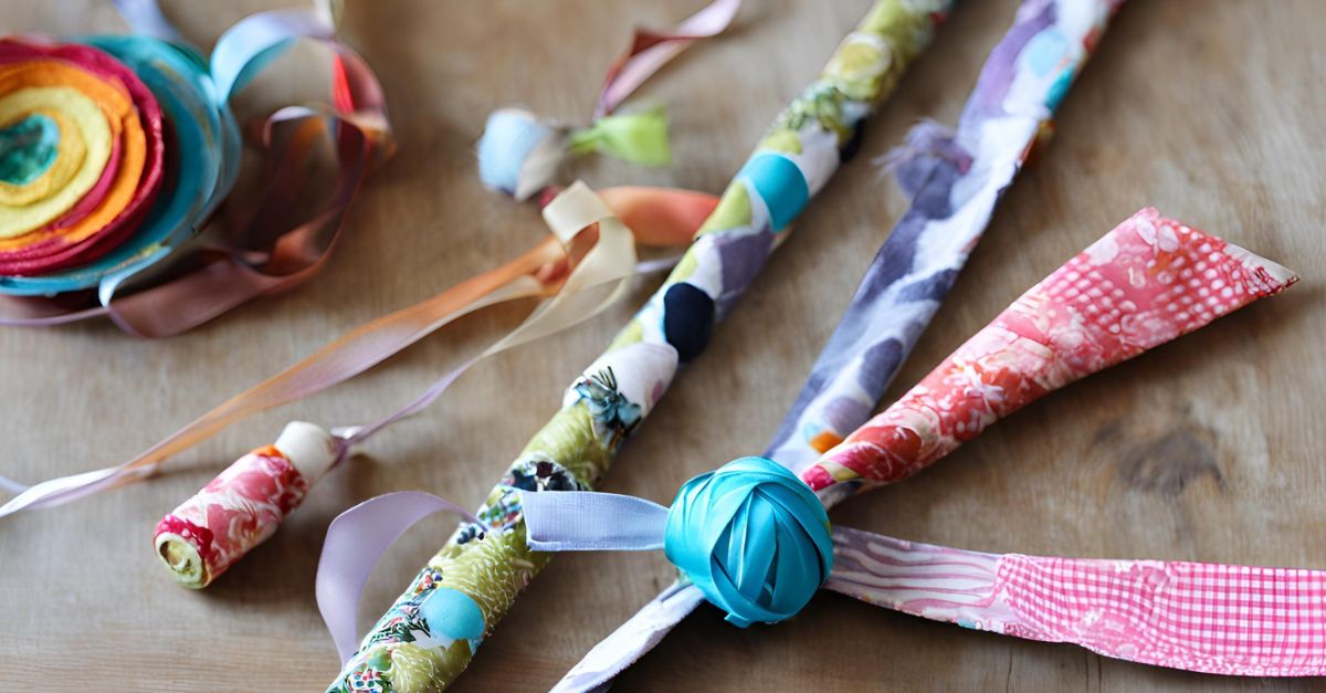 DIY fabric scrap ribbon wand cat toy with various textures and colors of fabric strips attached to a dowel
